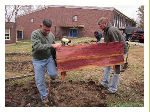 The team from of Landscape Solutions in Nashville help build and transplant the garden beds.