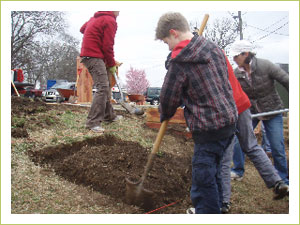 Preparing the soil for their new raised beds.